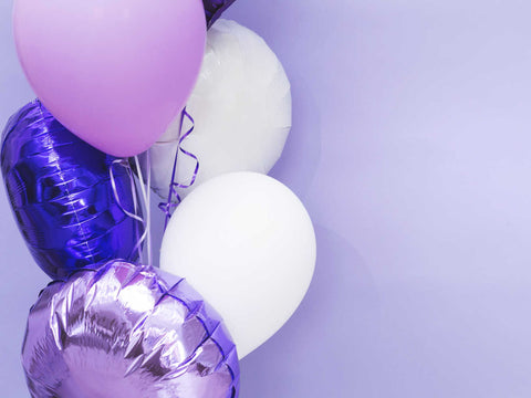purple and white balloons against purple wall