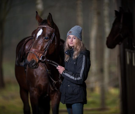 A picture of a woman with her horse.