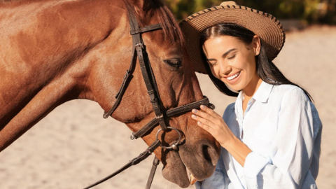 A woman hugging her horse.