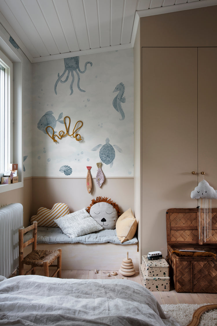 Ocean Friends, Pattern Wallpaper in blue featured on a wall of kid’s playroom with plushies and toys