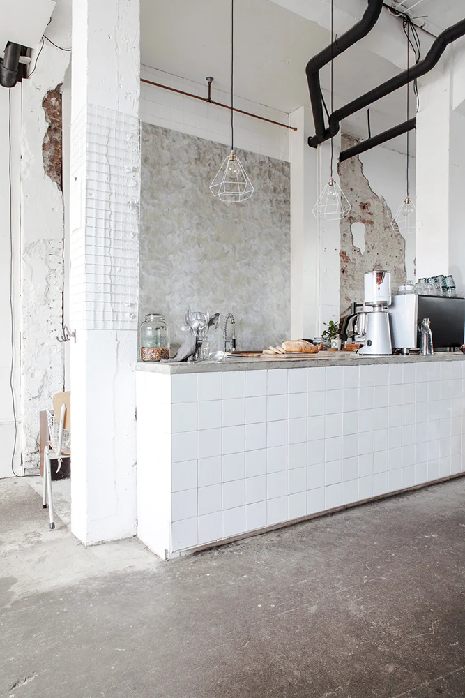 Polished Concrete wallpaper is showcased on a wall within a kitchen area adorned with a brutalist finish.