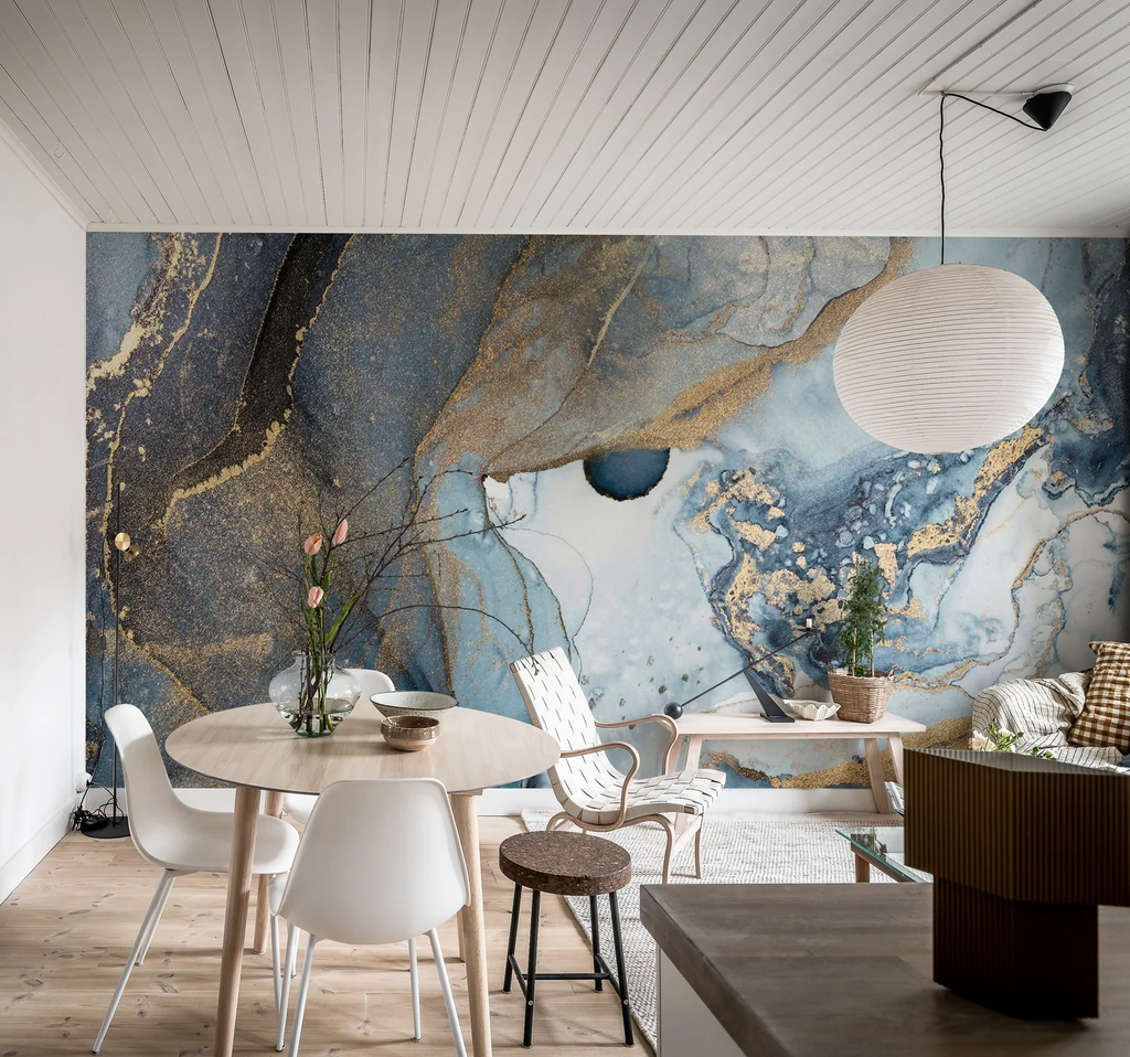 Agate Crystal Marble Texture Wallpaper in Blue featured in a living area with several white chairs, wooden round table with a vase with plant, and wooden flooring.