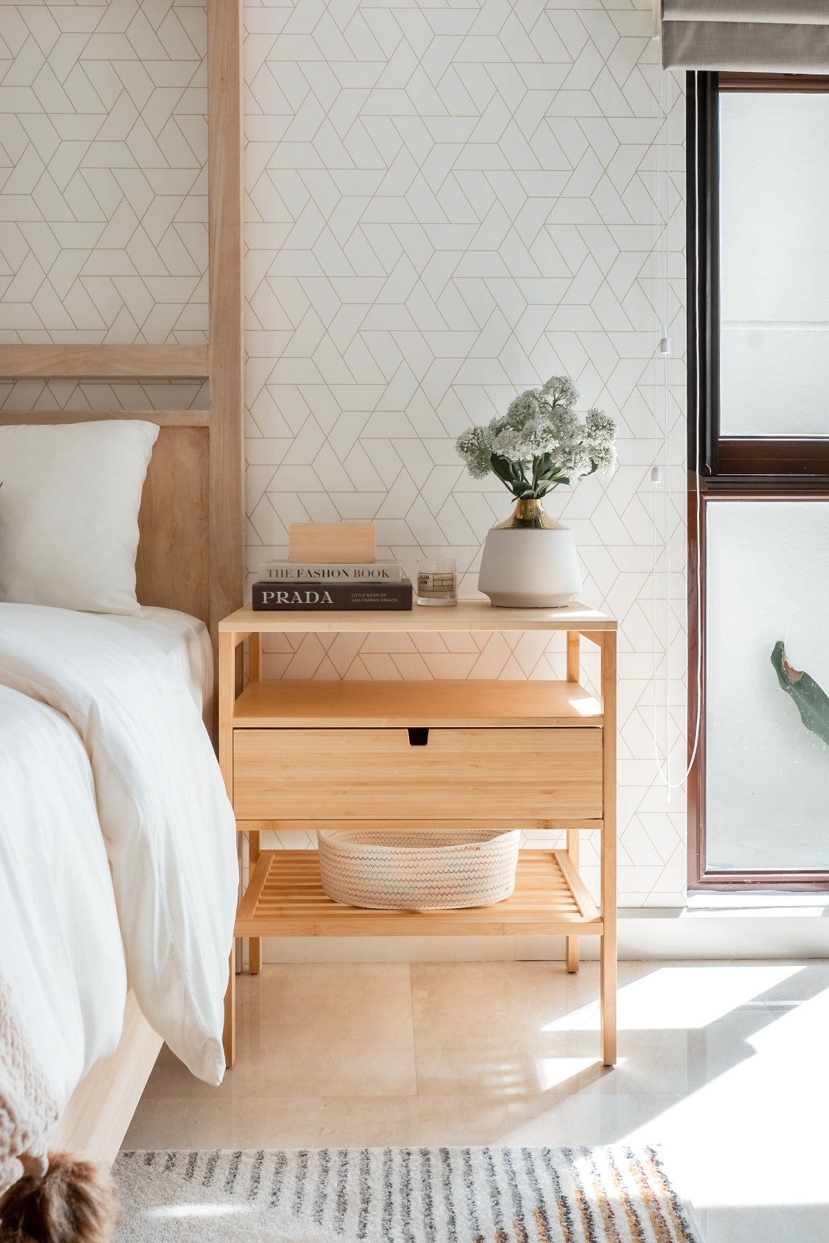 white geometric wallpaper in bedroom with wooden bed frame