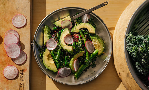 A Titanium Plate is filled with a Super Grain Salad with raw ingredients on either side.