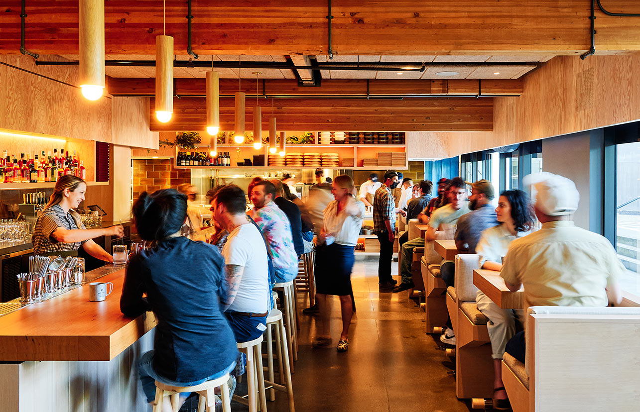 A bustling bar filled with people enjoying time together.