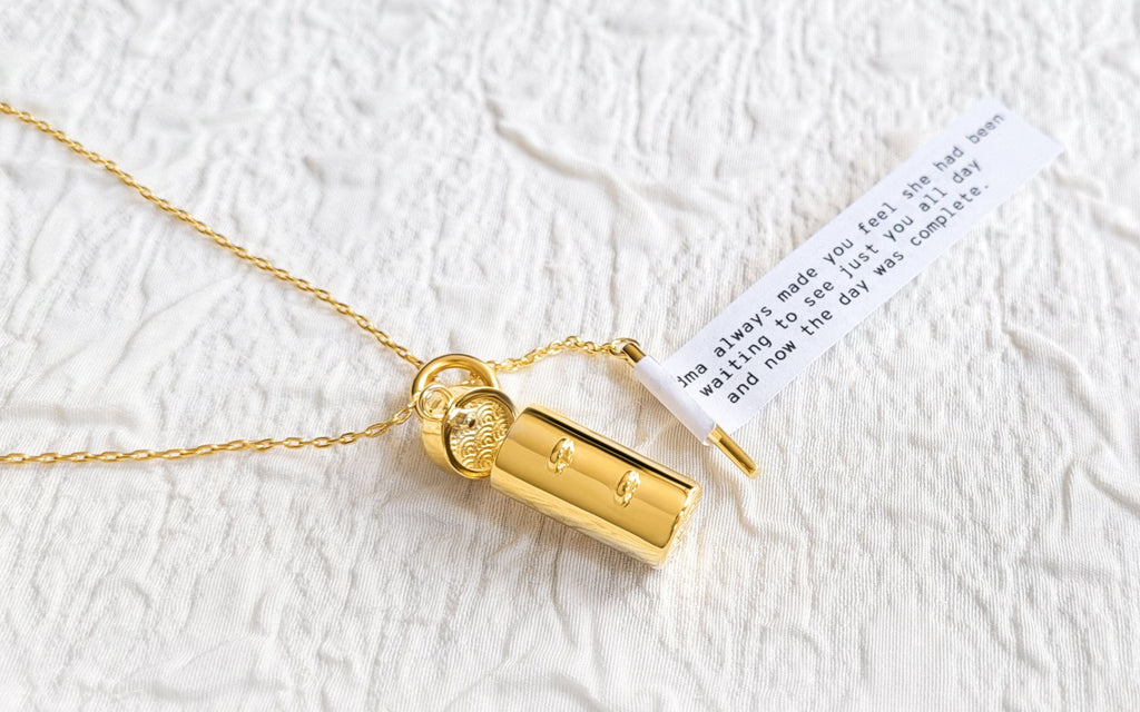 An open locket with a fortune on a crinkly white background.