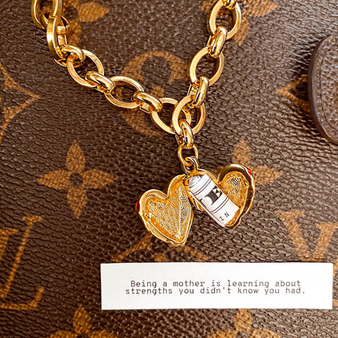 Our Heart Locket Necklace with a fortune that reads "Being a mother is learning about strengths you didn’t know you had."