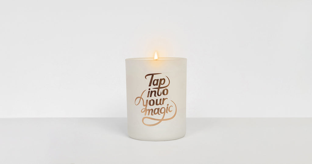 The "Tap into your magic." Secret Fortune Candle shown lit.