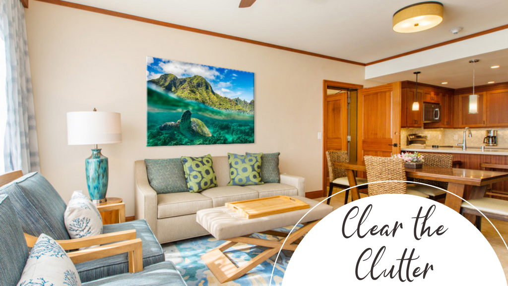 Clutter free hotel suite with kitchen and living room and beautiful wall art of hawaii