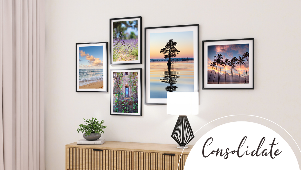 collection of favorite photographic prints on a wall, gallery style in black frames with white mats, above a dresser