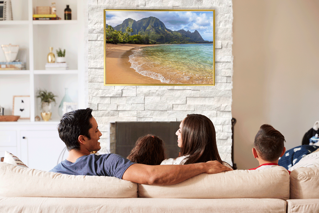 Family looking at a photo of Tunnels Beach in Kauai, reminiscing of their summer vacation