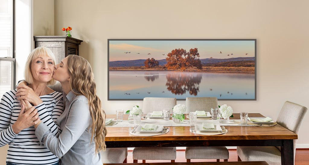 mom and daughter in dining room with table and artwork on wall behind them