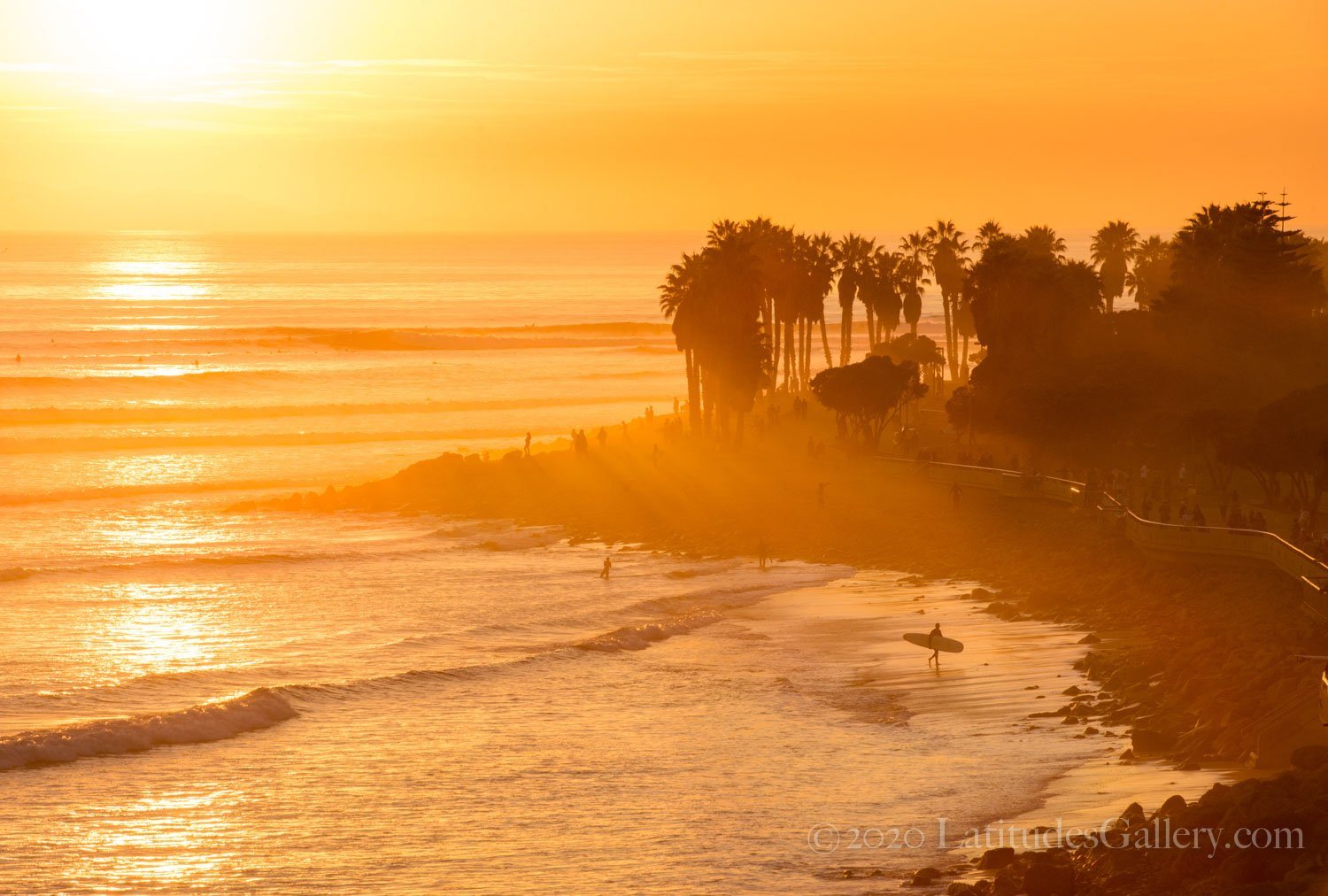 Office wall art of a Ventura surf spot bathed in the golden light of sunset as surfers leave the beach. 