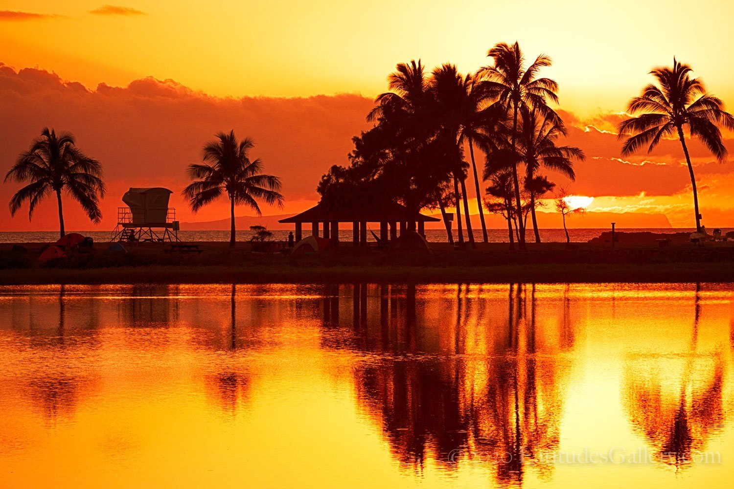 Sunset wall art of a bright orange classic Hawaiian sunset mirrored off still waters.