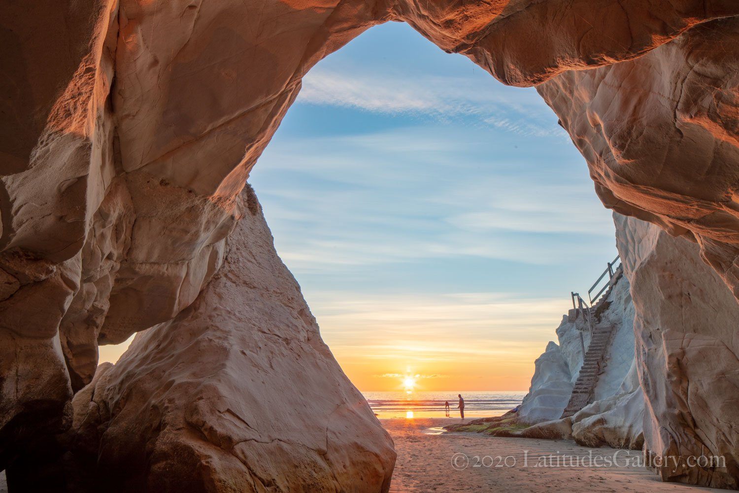 Coastal scene from a seaside cave along the beaches of Pismo, California as the sun sets behind the ocean.