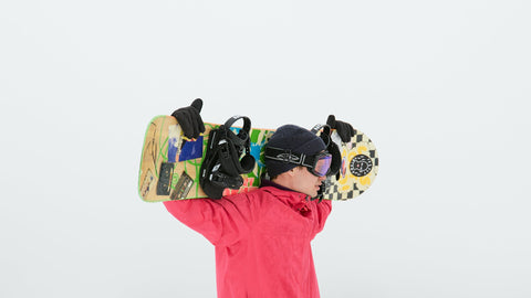 Snowboarder holding board