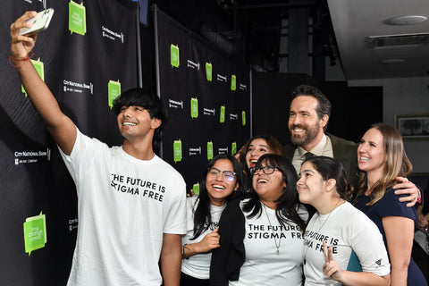 Teens pose with actor Ryan Reynolds in a selfie