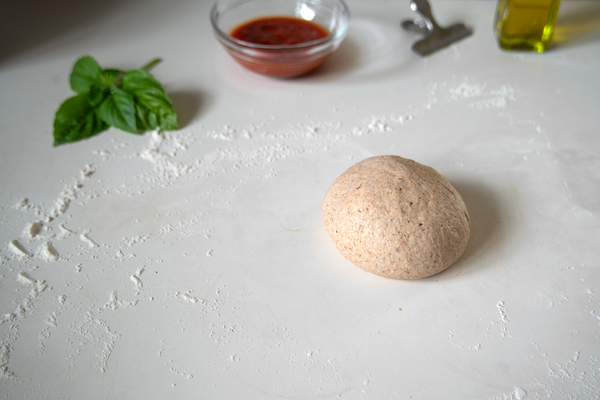 Pizza dough ball with basil