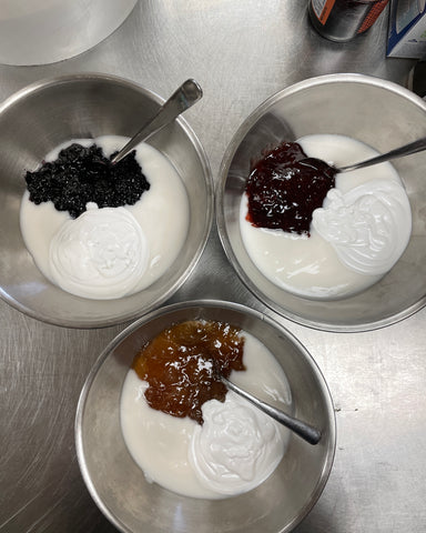 Jam, coconut milk, and coconut yogurt in a bowl to make vegan jam popsicles
