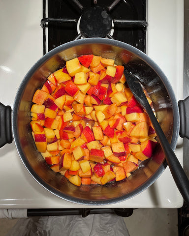 Peaches in a pot on a stove