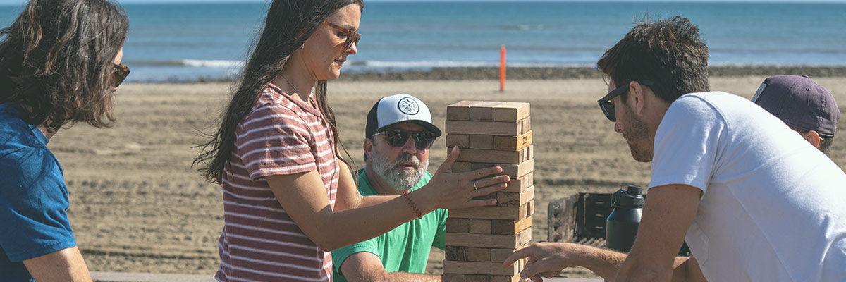 group of people playing wooden blocks game