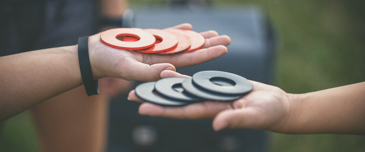 washer toss game rings in hand