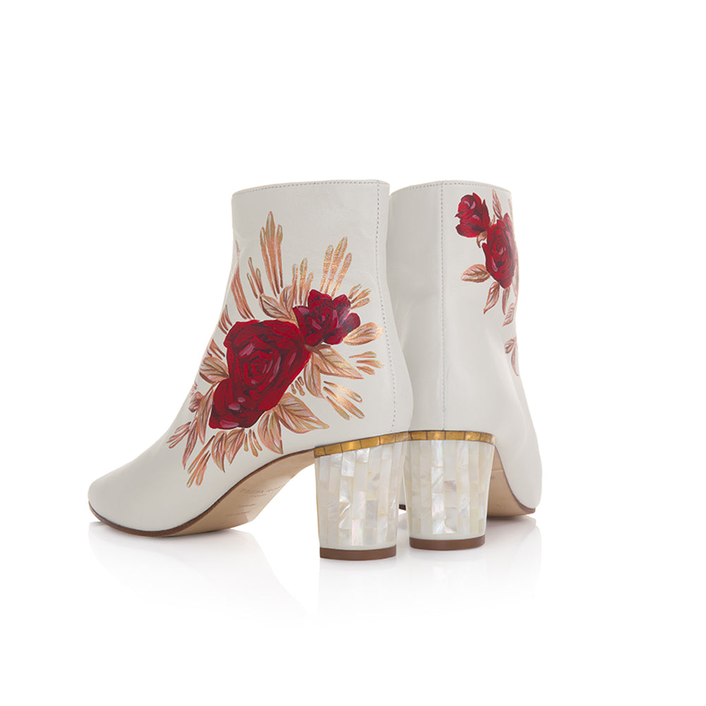 Freya Rose London June White Designer Wedding Boots with a Mother of Pearl statement heel and hand-painted red roses with bronze foil lines coming off them.