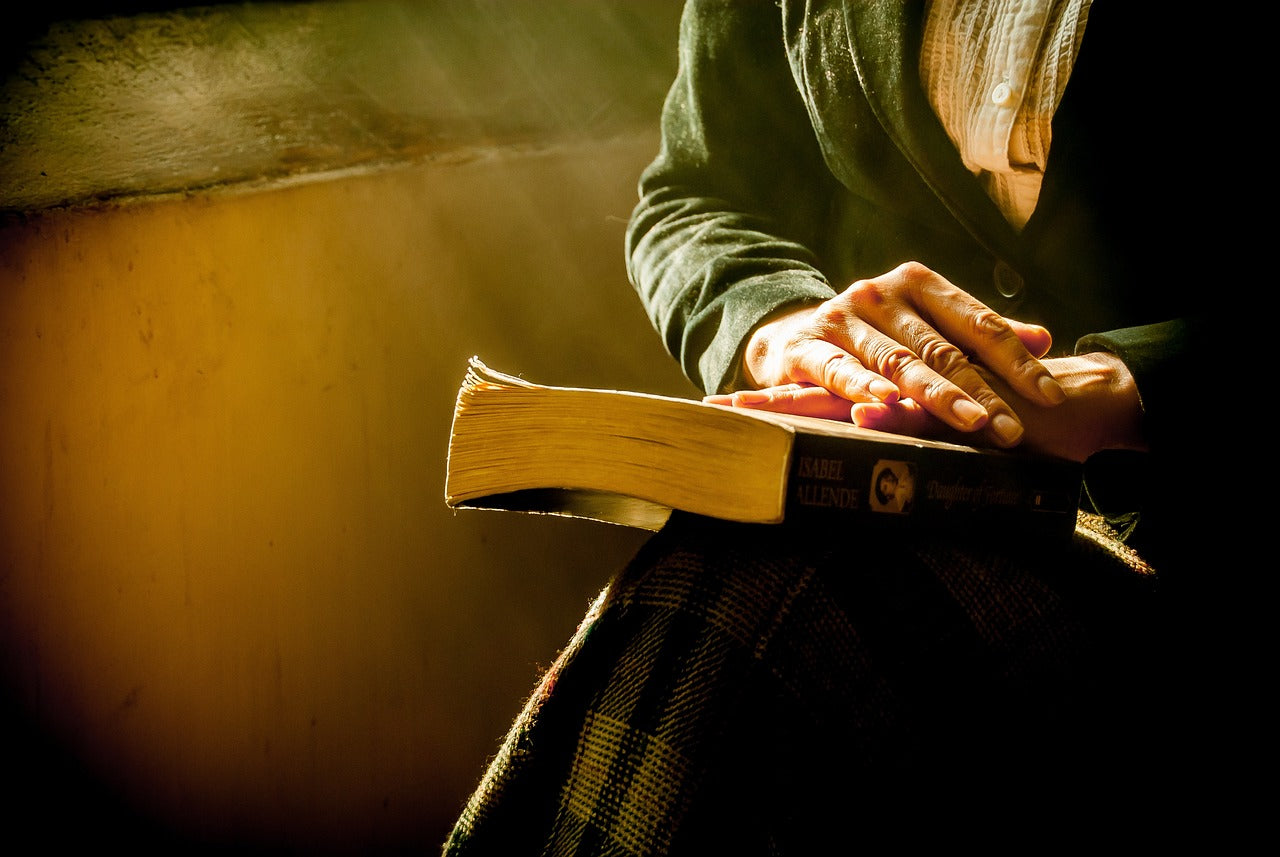 Woman holding a bible-Shaka Tribe