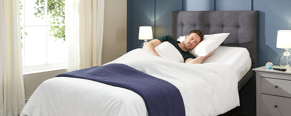 A man sleeping in an adjustable bed