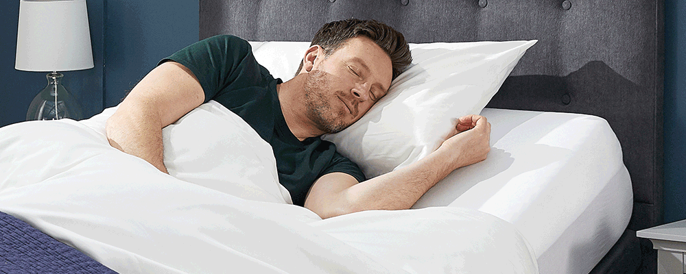 a man sleeping in an adjustable bed