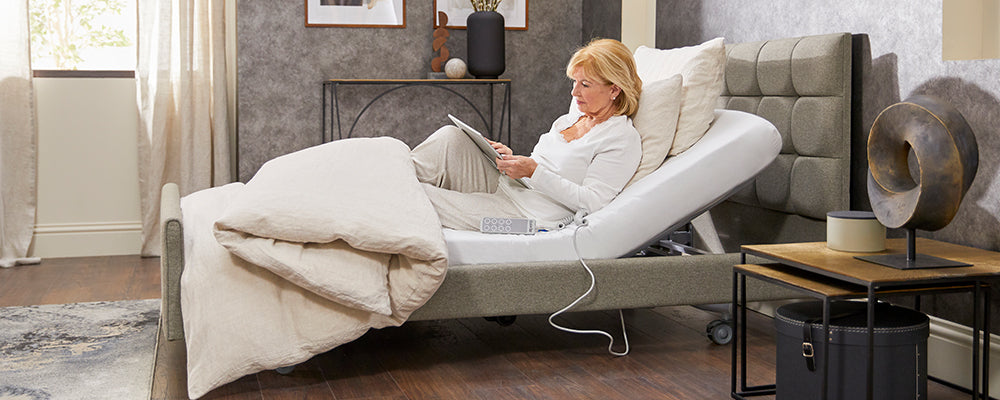 a lady using a table comfy in bed