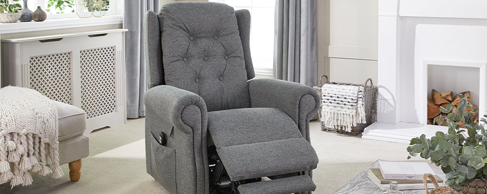 A grey riser recliner chair with the leg rest raised
