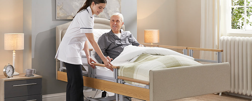 a care giver helping someone on a profiling bed