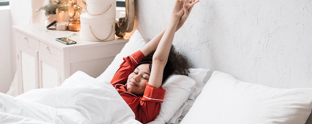 A lady stretching in bed