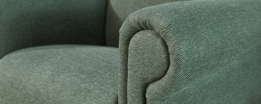 A close up of the armrest of a moss green woven riser recliner chair