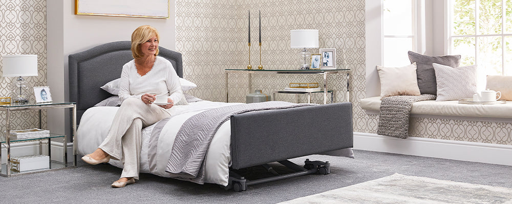 a ultra low bed with a lady sat on the side