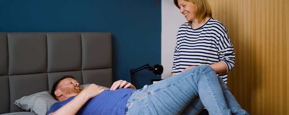 Naill having physio on the bed