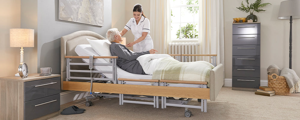 a care giver helping someone on a hospital bed