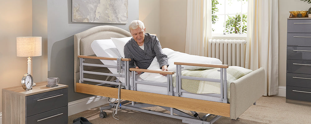 A man using the side rails on a opera prfiling bed