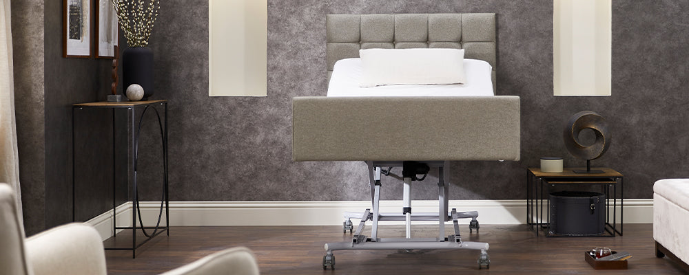 An Opera profiling care bed in its highest position where the whole bed is up high to waist level
