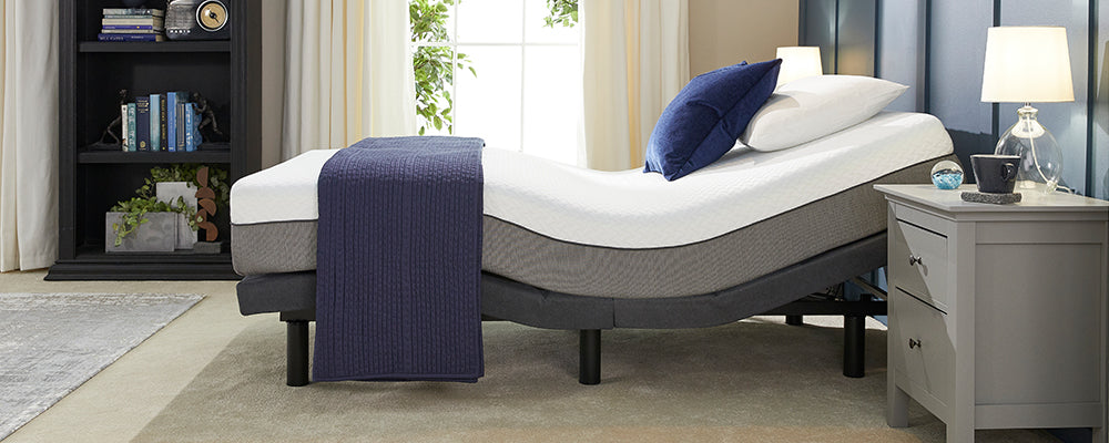 an adjustable bed in the raise positions with a mattress to show that a normal mattress wouldn't work with an adjustable bed