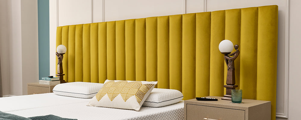 A mustard yellow panelled headboard on an adjustable bed