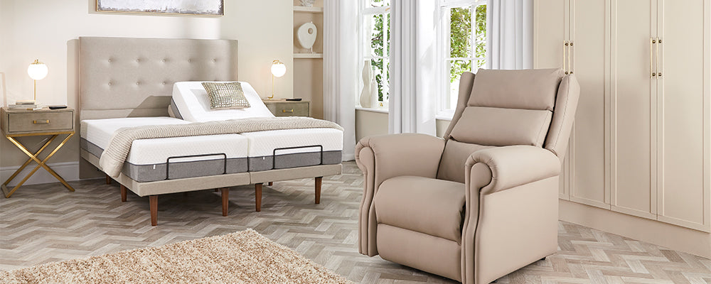 A cream coloured leather riser recliner chair in a bedroom with an adjustable bed with wooden legs