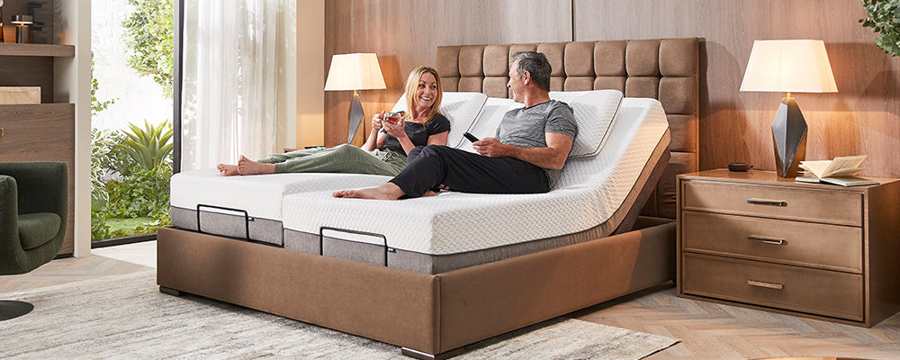 Stratton Adjustable bed with man and woman sat in bed with the back rest raised