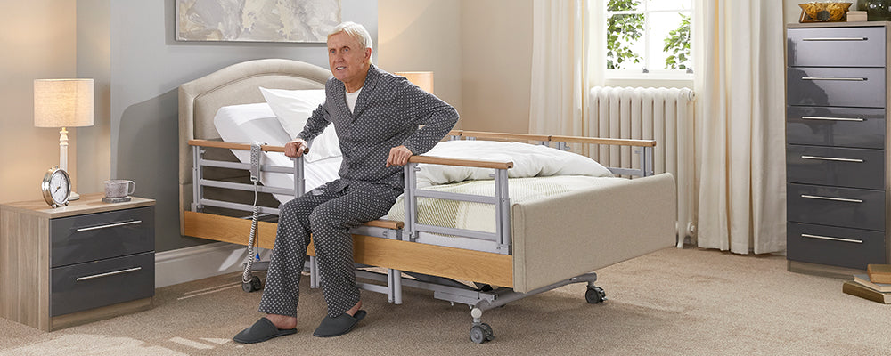 the elderly man getting out of bed using the side rails