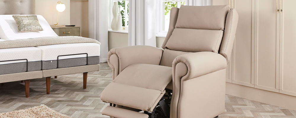 A cream leather riser recliner chair with the backrest reclined and the legrest raised