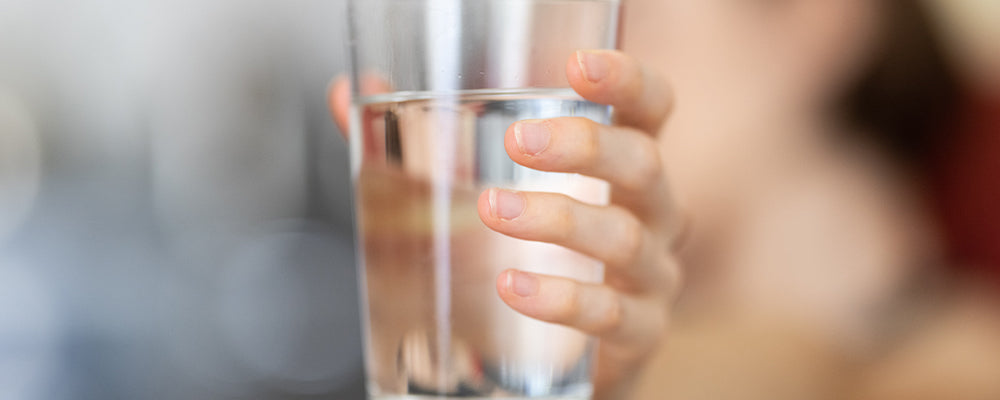 person holding a glass of water