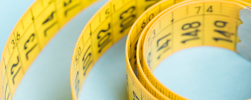 a yellow measuring tape on a blue background