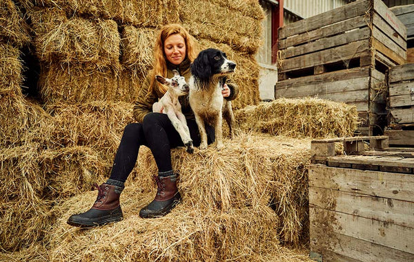 ZOË COLVILLE with lamb and dog