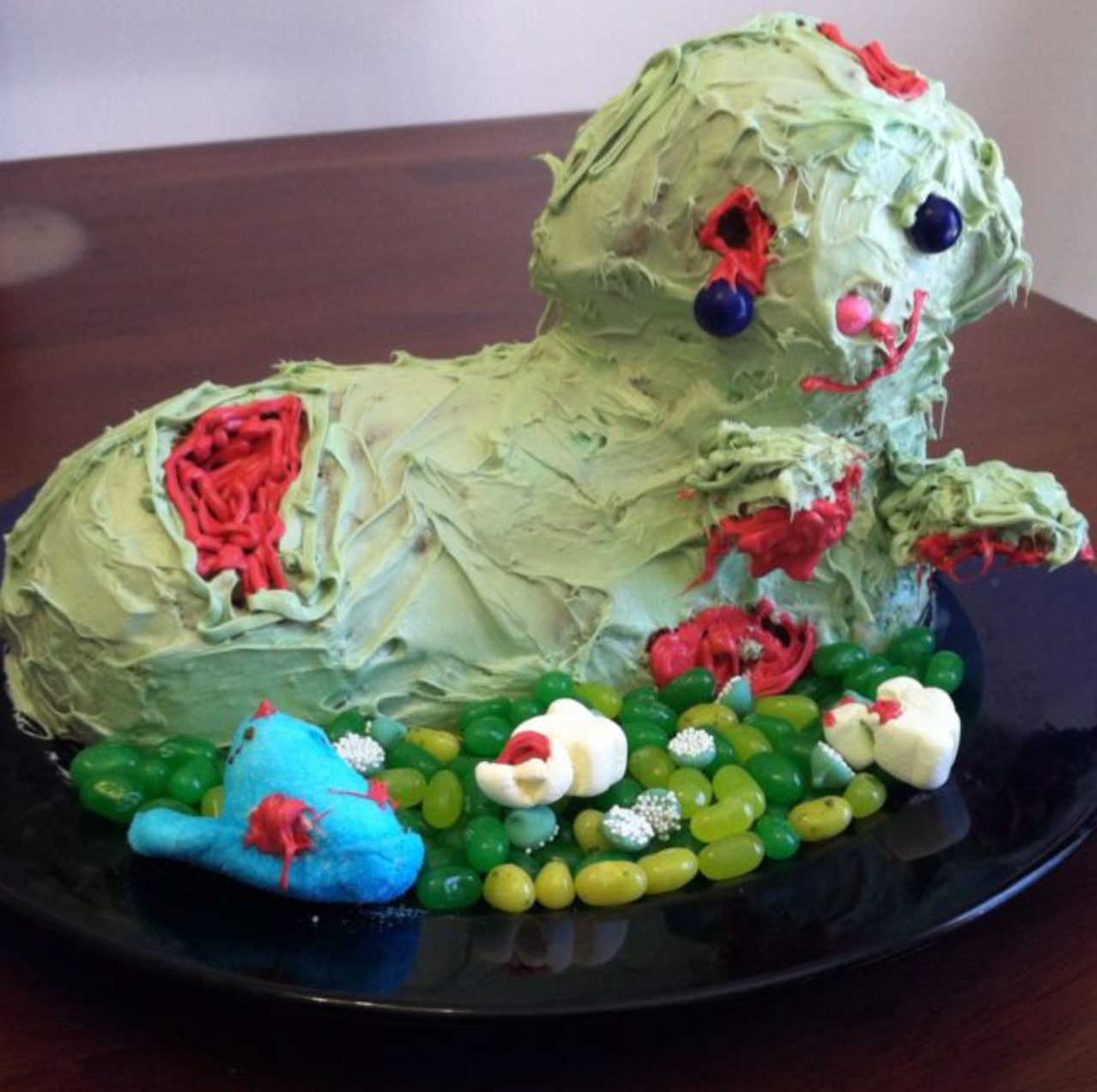 zombie themed easter lamb cake with green icing and bite marks, perfect for easter-ween, spooky easter, halloween easter, easterween holiday.
